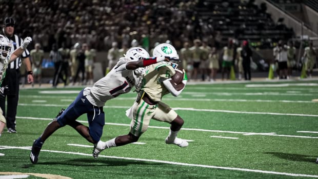 Week 5: Chaminade-Madonna defender Zaquan Patterson goes airborne to try to get ahold of Buford running back Victor Venn. (Photo by Josh Major)